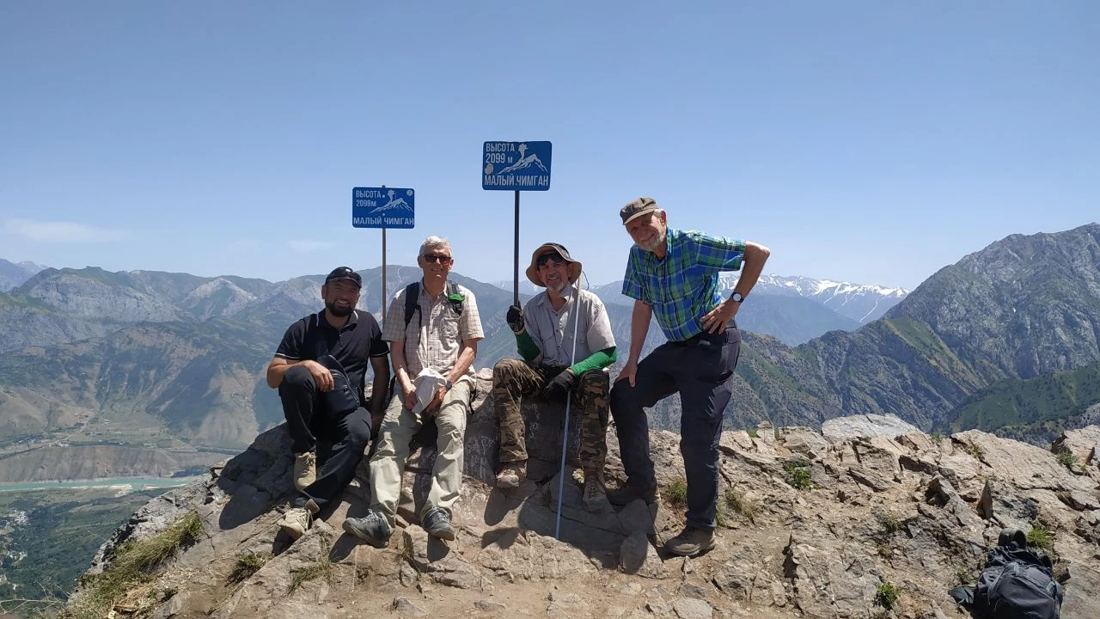 Group of hikers at the Small Chimgan summit, 2099m