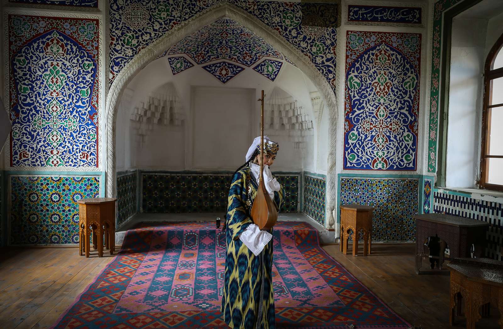 Long sleeves and a covered head in a tiled hall: roughly what a mosque visit asks of you