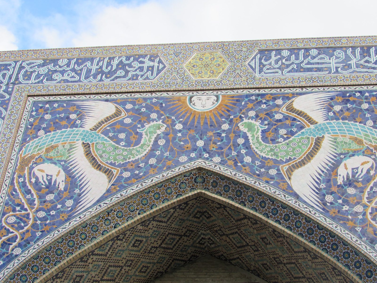 Two simurghs and a sun with a human face on the portal of the Nadir Divan-Begi madrasah