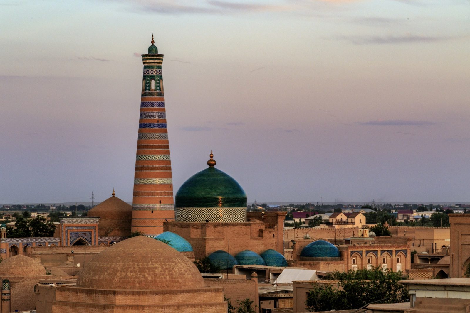 The Islam Khoja minaret and the dome of Pahlavan Mahmud in the evening