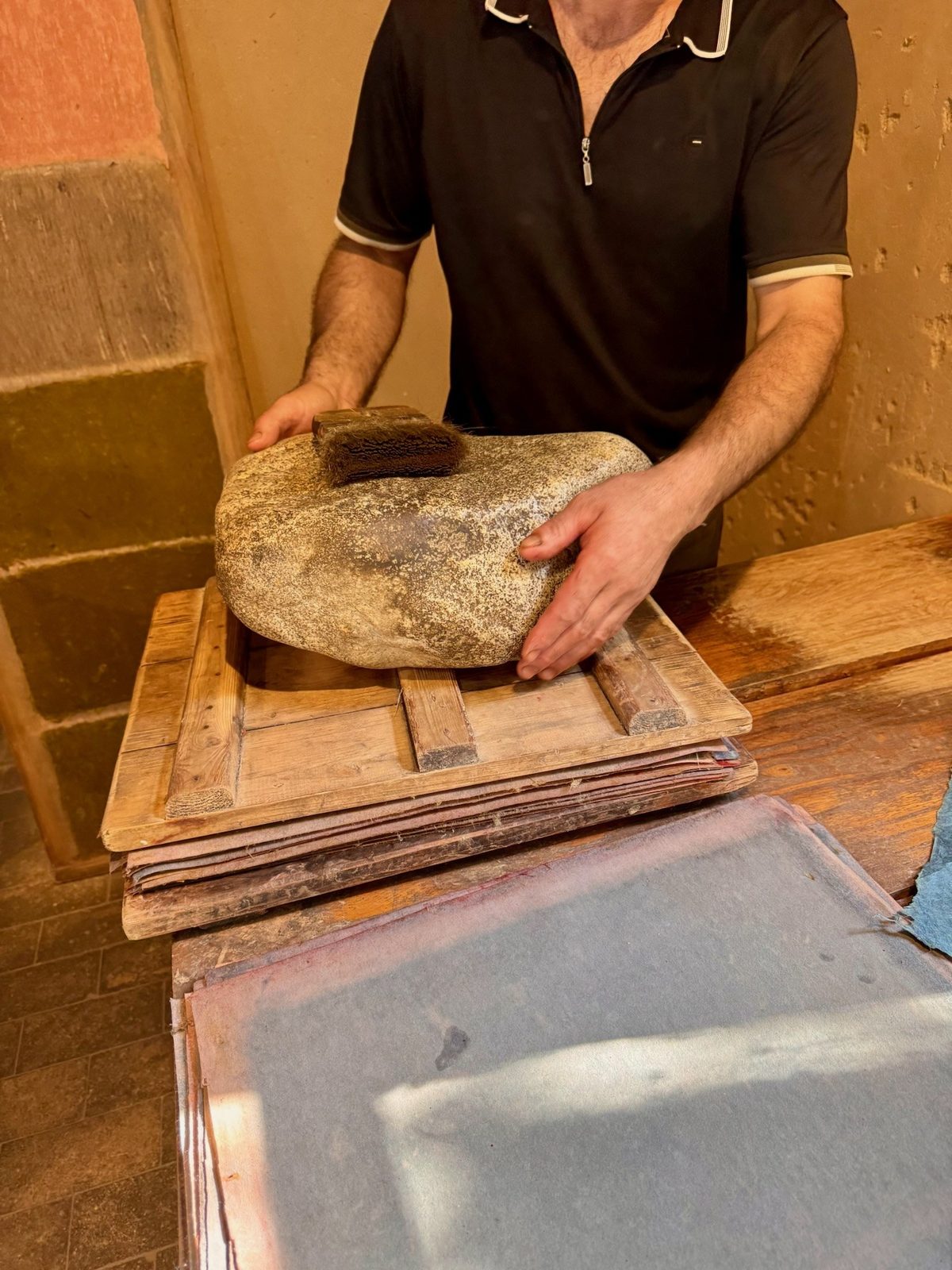 Polishing a sheet of mulberry paper with a stone, Konigil near Samarkand