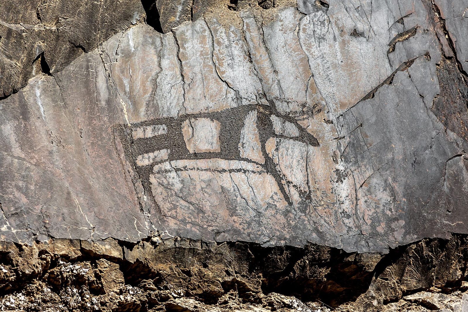 A bull with a geometric patterned body carved on a rock